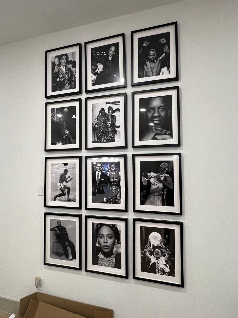 Gallery wall with 12 framed photos assembled in Houston home